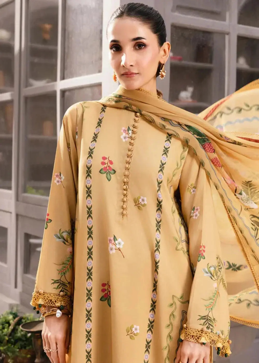 Close-up of MB-CUS25-1105-B Maria B Ready to Wear shirt showing intricate floral embroidery and button detailing on peach orange fabric.