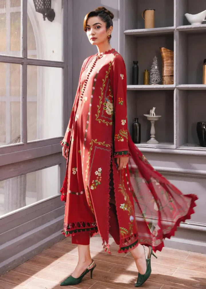 Side profile of MB-CUS25-1105-A stitched winter suit by Maria.B with red floral shirt, matching trousers, and flowing chiffon dupatta.