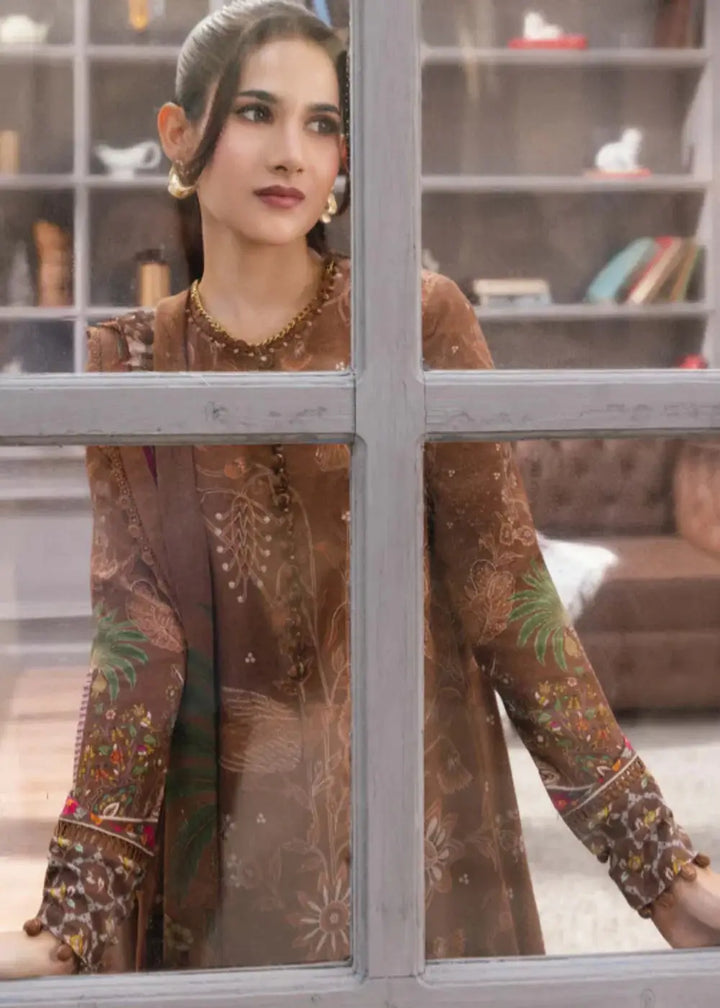 Model wearing MB-CUS25-1106-B - Maria B Dress Women, featuring floral digital prints and vibrant sleeve accents in a warm brown winter outfit.