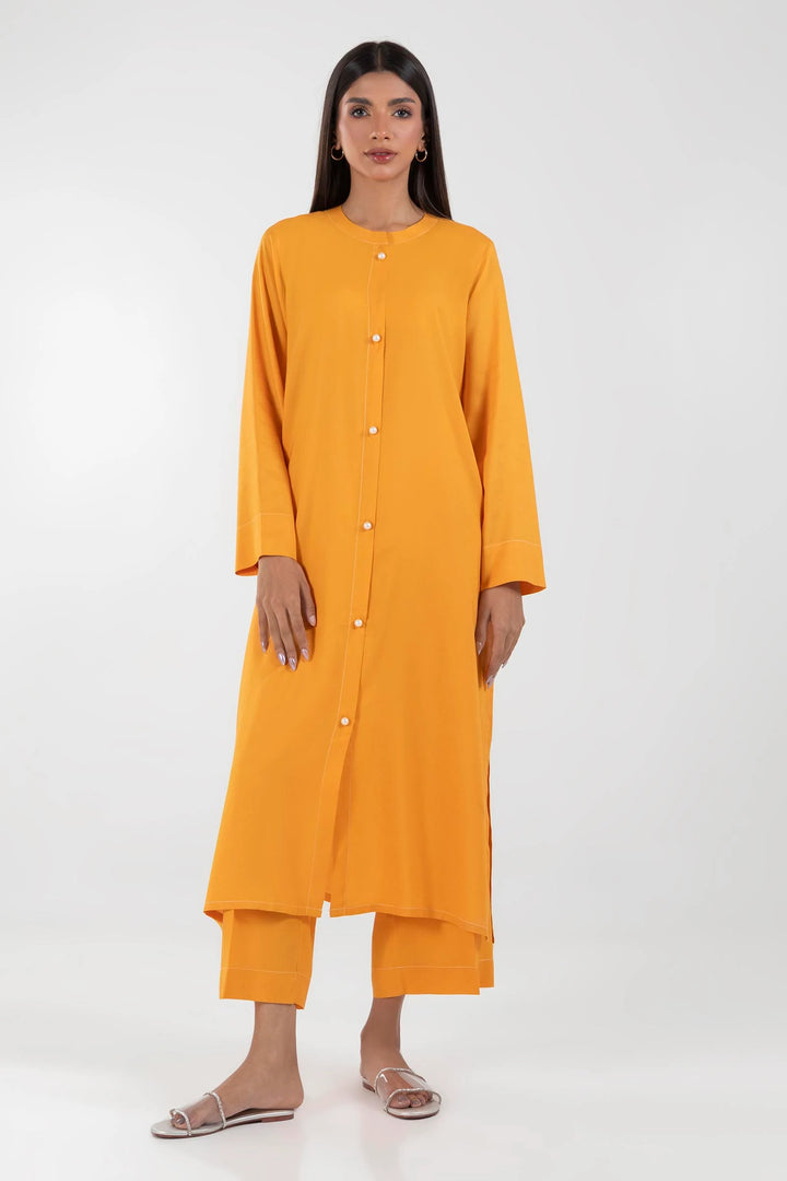 a woman wearing an orange tunic and pants