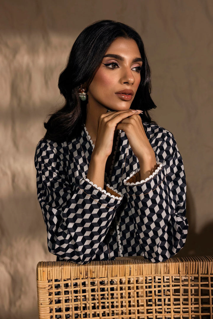 a woman in a black and white checkered shirt leaning on a wicker basket