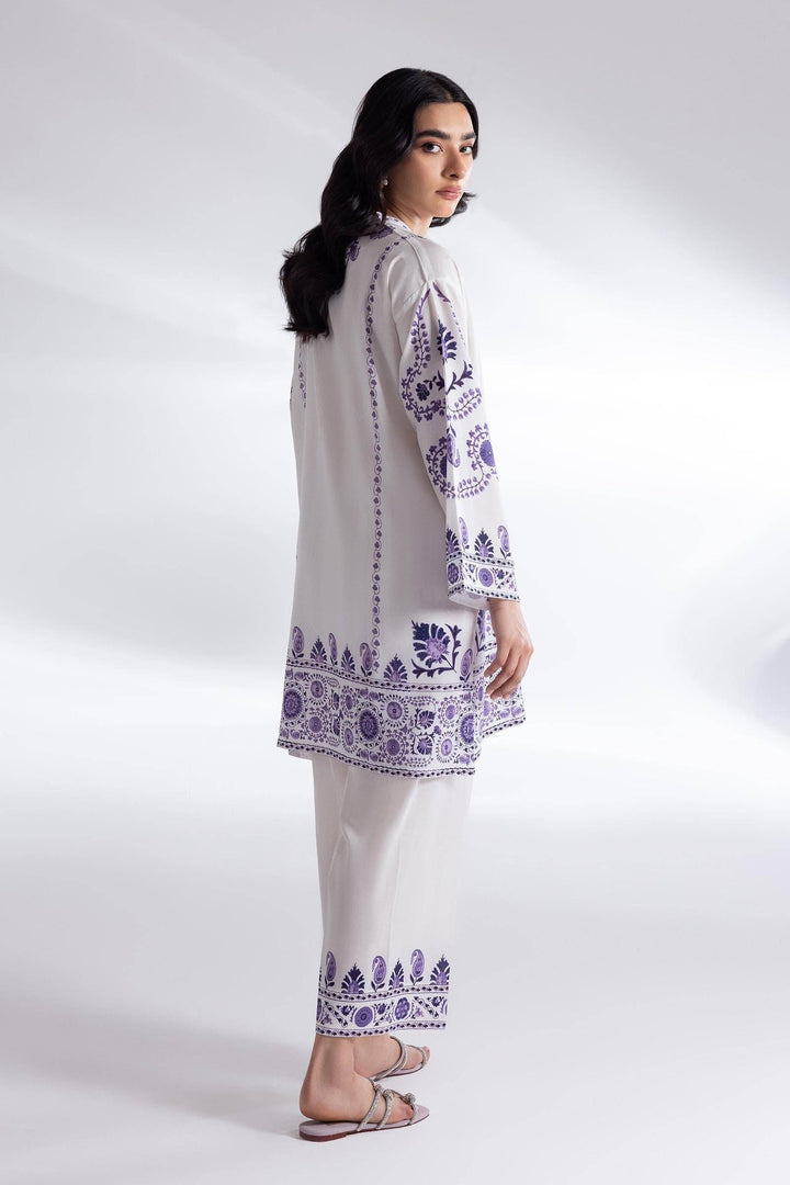 Back view of SANA SAFINA basic linen suit featuring intricate purple embroidery on a white shirt and culottes, perfect for everyday fashion.