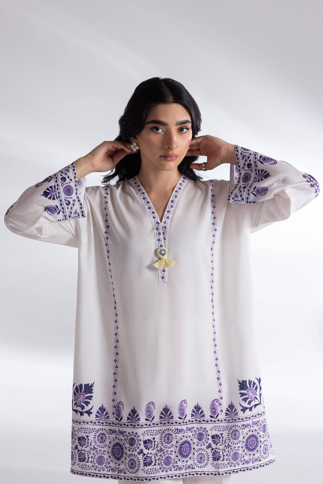 Close-up of SANA SAFINA white linen shirt with purple embroidery and V-neckline, showcasing elegant detailing for versatile daily outfits.
