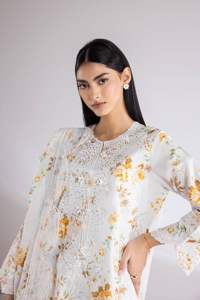 Close-up of SANA SAFINA Dress showcasing intricate embroidery on off-white lawn fabric with yellow floral accents. Stylish neckline and sleeve detail.