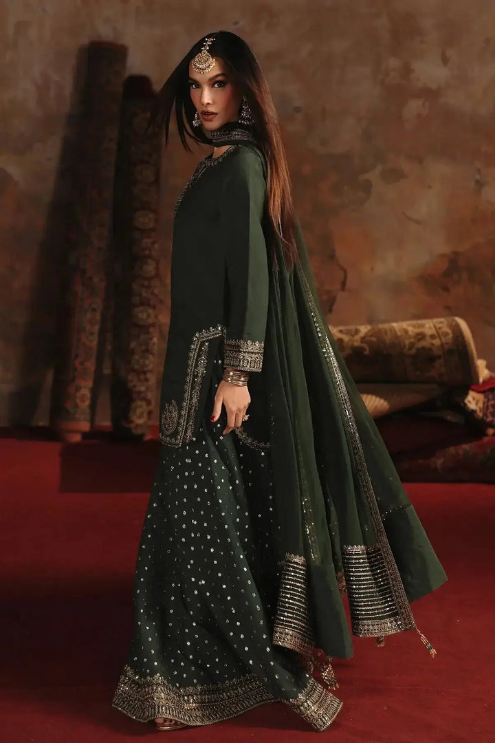 Stylish dark green embroidered raw-silk suit with silver embroidery, complemented by traditional jewelry, perfect for festive or wedding events