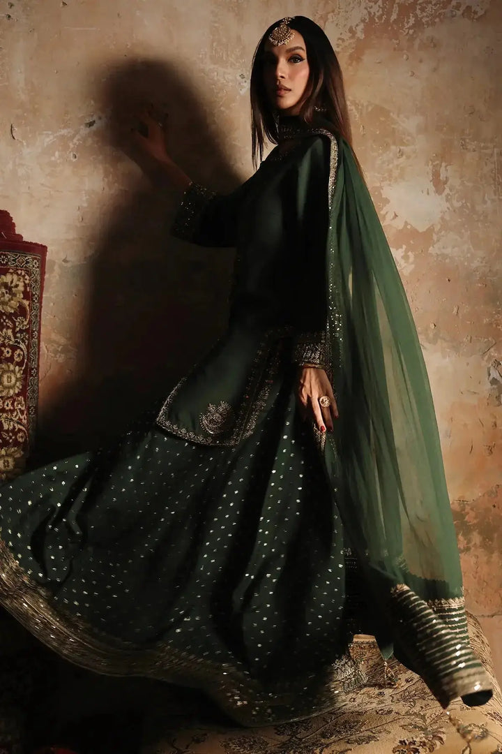 Elegant black and green embroidered raw-silk suit with intricate embellishments and flowing dupatta