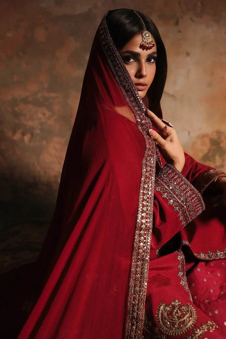 Red embroidered raw-silk suit with intricate gold embellishments and dupatta